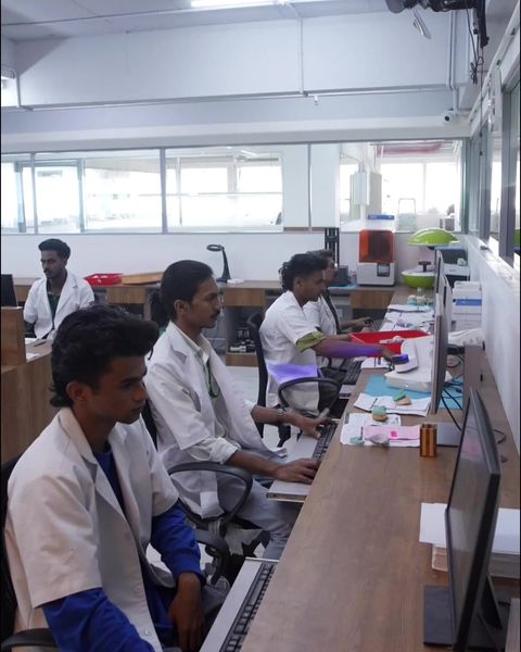 Dental technicians designing restorations on computers in the Denco design room