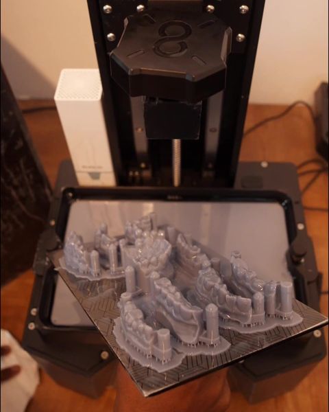 Resin dental models on the build plate of a 3D printer